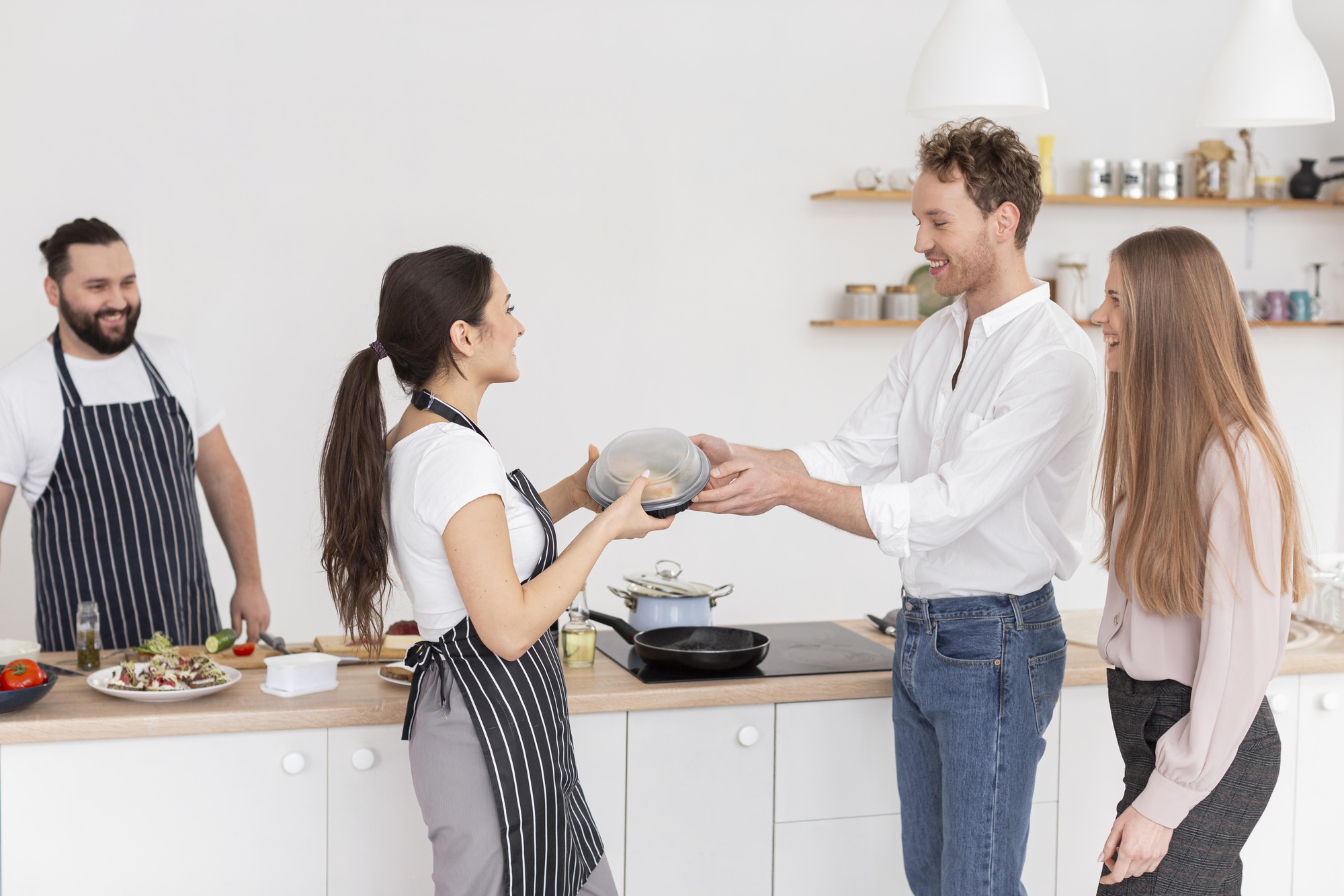 Instructor greeting participants in a modern kitchen